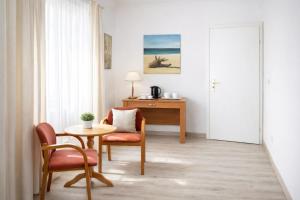 a room with a table and chairs and a desk at Pensjonat u Bernackich in Smołdzino +67 photos