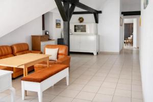 a living room with a table and a couch at Pensjonat u Bernackich in Smołdzino