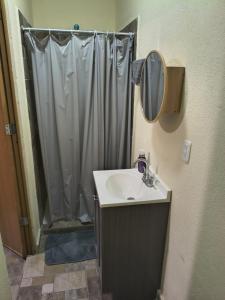 a bathroom with a shower with a sink and a mirror at El Cubanito Cafe y hospedaje in León +30 photos
