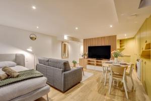 a living room with a couch and a dining room at Basement studio- Montparnasse Station in Paris
