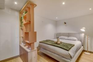 a bedroom with a bed with two teddy bears on it at Basement studio- Montparnasse Station in Paris