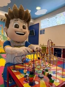 a young boy is playing with a toy maze at Centromar Hotel in Balneário Camboriú