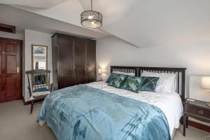 a bedroom with a large bed with a blue blanket at Preswylfa in Cemaes Bay