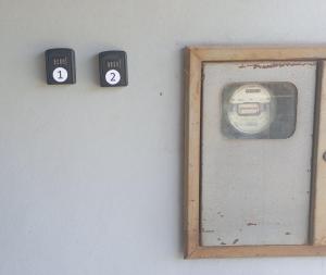 a wall with two black clocks with numbers on it at Quarto suíte 1 in Itaqui