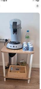 a coffee maker on a stand in a kitchen at Appartement T2 cosy in Canteleu