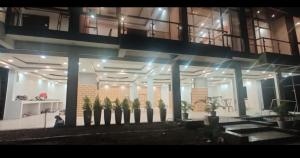 a large building with potted plants in front of it at 7 Vachan Garden and Resort in Bhopal