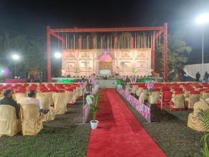 a stage with chairs and a red carpet at 7 Vachan Garden and Resort in Bhopal