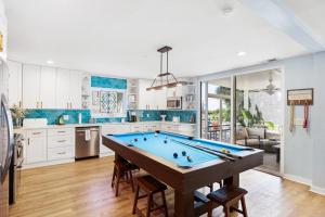 a large kitchen with a pool table in it at Sandy Paws Retreat - 30 Day Rental in Folly Beach