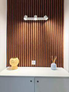 a yellow toilet sitting on a counter in front of a wooden wall at The White Balcony in Il-Gżira