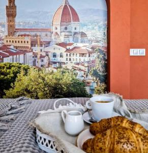 a table with two cups of coffee and a plate of bread at Mayachok Boutique hotel in Kyiv