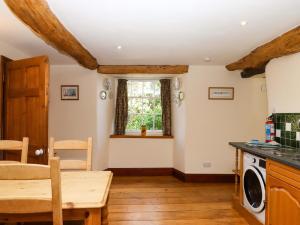 a kitchen with a table and a dining room at Oak Tree in Halwell