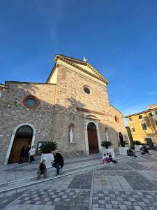 a group of people sitting in front of a church at Le Tre Capanne in Marina di Carrara