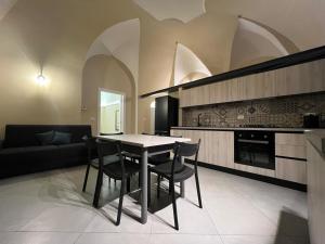 a kitchen with a table and chairs in a room at Il Poggetto Bed and Breakfast in Bovino