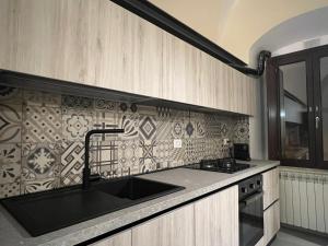 a kitchen with a sink and a stove at Il Poggetto Bed and Breakfast in Bovino +5 photos