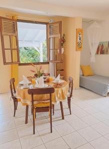 a dining room with a table and chairs at De l'îlet au Volcan in Basse-Terre +4 photos