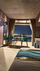 a room with a bed and chairs on a boat at Privee Dhaka - PRIVEE RESORT & RESTAURANT in Bholānāthpur