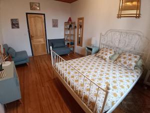 a bedroom with a bed and a living room at Les maisons de Gaïa Chambre d'hôte climatisée in Tuchan +8 photos