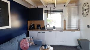 a living room with a couch and a kitchen at Domki Ale Góry Beskid Żywiecki Korbielów in Korbielów
