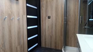 a bathroom with a shower and a glass door at Domki Ale Góry Beskid Żywiecki Korbielów in Korbielów +26 photos
