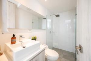 a bathroom with a sink and a toilet and a shower at Luxury Jacuzzi in Poblado in El Poblado