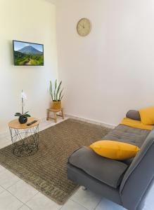 a living room with a bed and a table at De l'îlet au Volcan in Basse-Terre