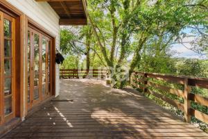 a walkway to a house with a fence and trees at Suíte Front Cyclists' Paradise in Gramado