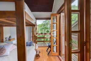 a room with a bed and a large window at Suíte Front Cyclists' Paradise in Gramado