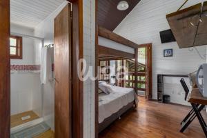 a bedroom in a house with a bed and a bathroom at Suíte Front Cyclists' Paradise in Gramado +13 photos
