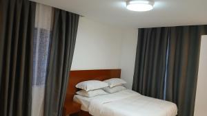 a bedroom with two beds and a window at Jacaranda Home in Mbeya