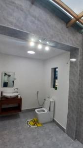 a bathroom with a toilet and a sink at Jacaranda Home in Mbeya