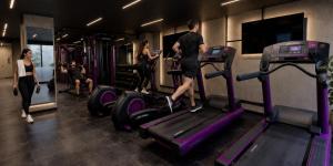 a man and woman on a treadmill in a gym at Origen 438 Luxury Boutique Hotel in Guadalajara +60 photos