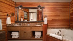 a bathroom with a tub and a large mirror at The Whiteface Lodge in Lake Placid +50 photos