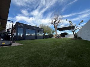 a building in a field of grass with a tree at Hostal Gran Capitán in Toledo