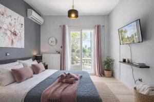 a bedroom with a bed with a teddy bear on it at Ilios Place Corfu-Near Old Town & Beaches in Kontokali