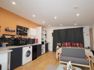 a living room with a bed and a kitchen at Faodail Studio in Portree +9 photos