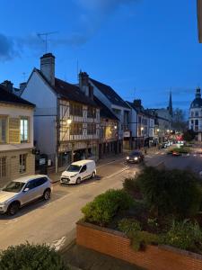 two white cars parked on a street in a town at Spa - Sauna privatif centre parking gratuit in Troyes
