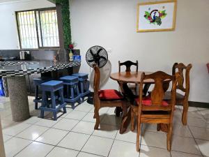 a kitchen with a table and chairs and a counter at Casa Sol in Sarapiquí