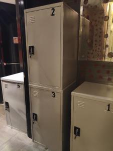 two white cabinets and a counter in a room at 1920's Rooms & Beds in Kalamata +76 photos