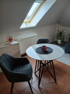 a living room with a white table and chairs at Kranich in Wieck