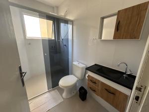 a bathroom with a toilet and a shower and a sink at Apartamento Premium Liberdade in São Paulo