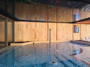 a large swimming pool in a room at Wave Apartments by Solarento in Międzyzdroje