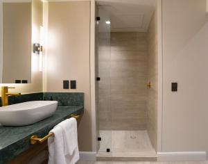 a bathroom with a sink and a shower at Hotel Core Suites Estadio Akron in Zapopan +76 photos