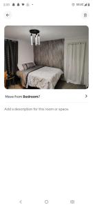 a room with a bed and a mirror at Nash Place in Akron +2 photos