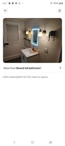 a picture of a bathroom with a sink and a mirror at Nash Place in Akron