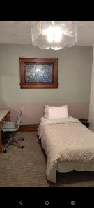 a bedroom with a bed and a desk and a chair at Nash Place in Akron