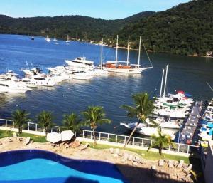 a view of a marina with boats in the water at Inefável flat Porto Marina Resort in Mangaratiba