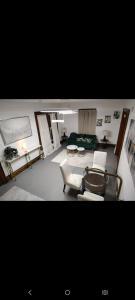 a living room with white chairs and a couch at Nash Place in Akron