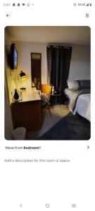 a bedroom with a bed and a desk with a television at Nash Place in Akron