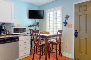 a kitchen with a table with chairs and a microwave at Oceanbound in Folly Beach