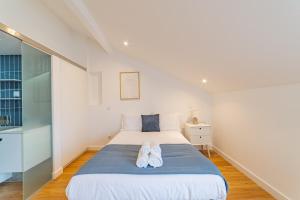 a bedroom with a bed with shoes on it at Hygge Smart Stays in Lisbon